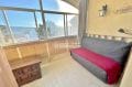 vente appartement rosas, studio 36 m² vue mer, véranda avec canapé et table basse, vue montagne